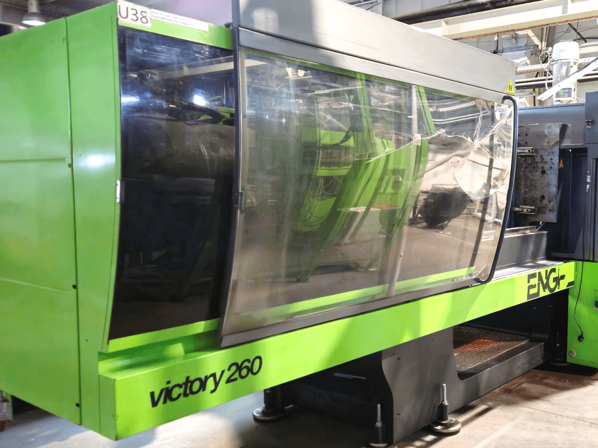 Vstřikovací stroj ENG victory 260, pohled zepředu; má zelený exteriér a velký skleněný panel pro lepší viditelnost.