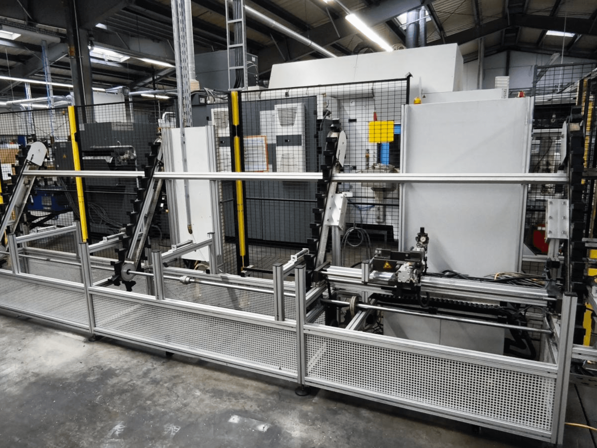 Systém LOHMEIER Schräglademagazin pro manipulaci s obrobky v čelním pohledu, který ukazuje jeho kovovou konstrukci a integrované mechanické komponenty.