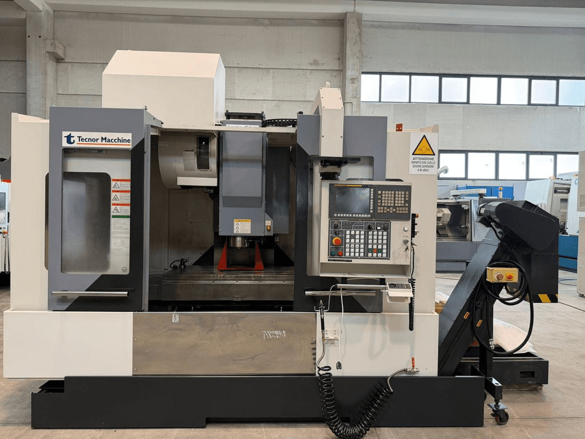 Frézka Tecnor Machine CNC, pohled zepředu, ovládací panel s tlačítky, výstražné štítky a držák nástrojů.