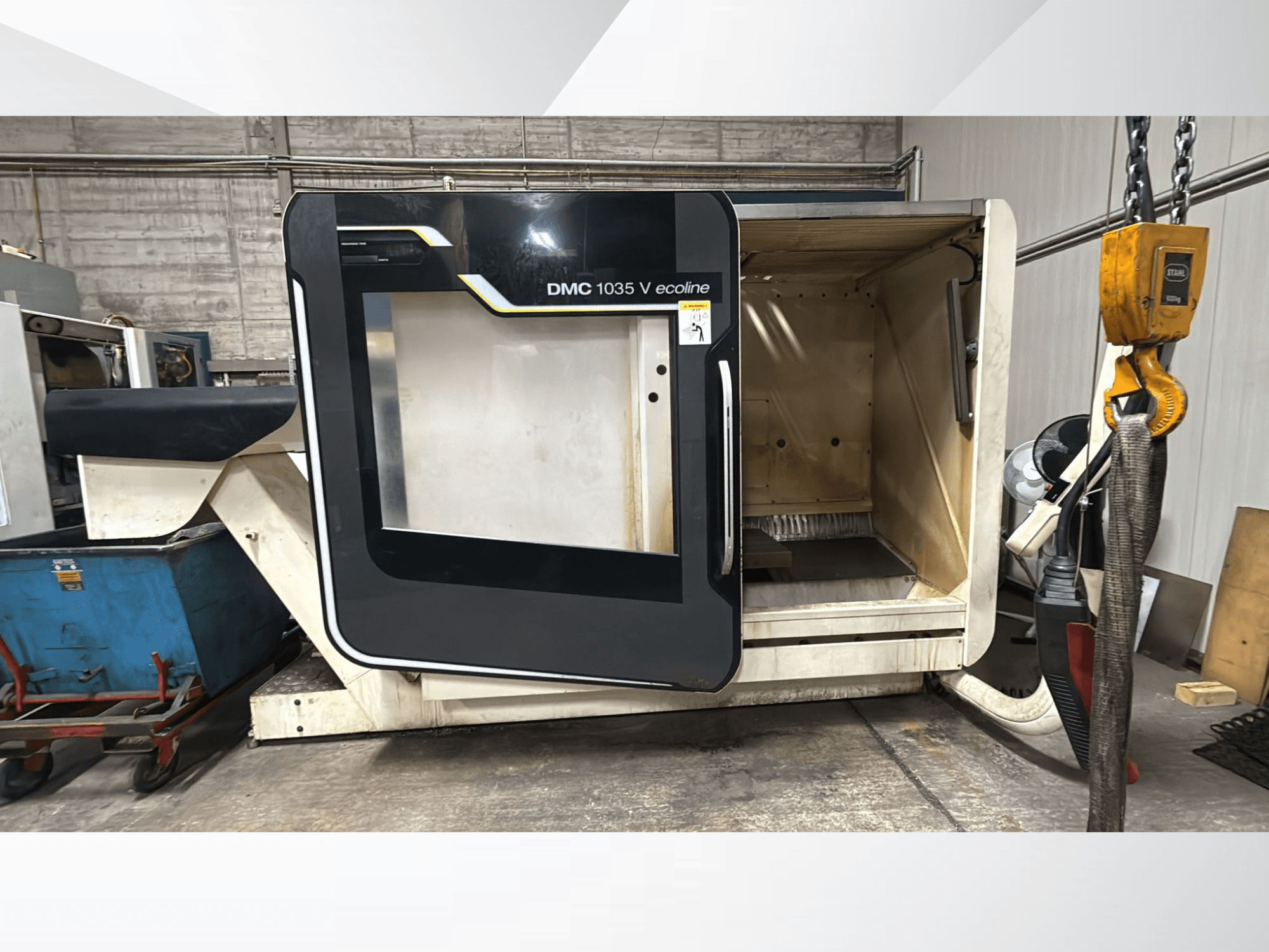 Stroj DMC 1035 V ecoline CNC, pohled zepředu, otevřené dveře odhalují prázdný interiér a ovládací panel.