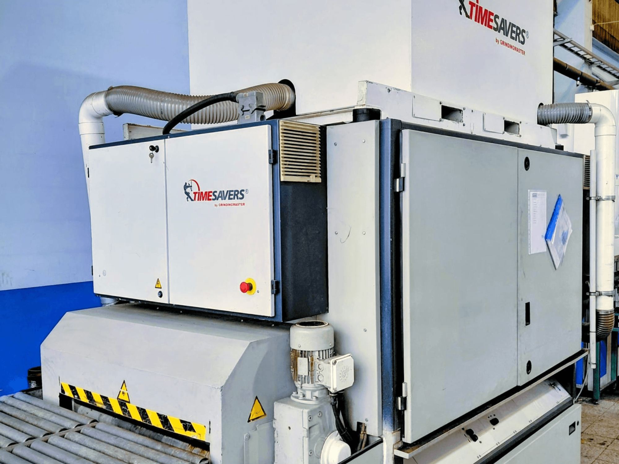 Průmyslová bruska TIME SAVERS, pohled z boku, s nastavitelným válcem, ovládacím panelem a systémem odsávání prachu.