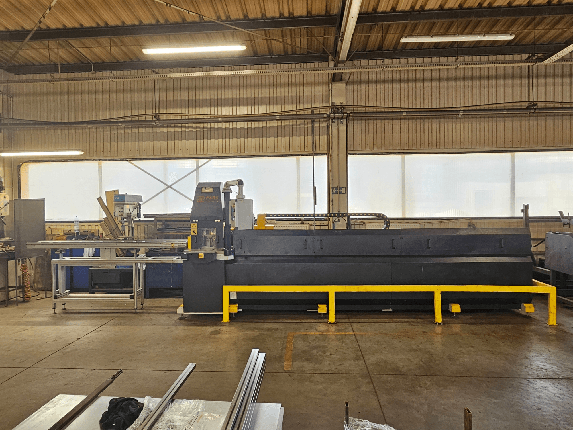 CNC děrovací stroj PARS HMP SIRIUS PLUS-3000/3-L1, pohled zepředu v průmyslovém prostředí s kovovým povrchem a nástroji.
