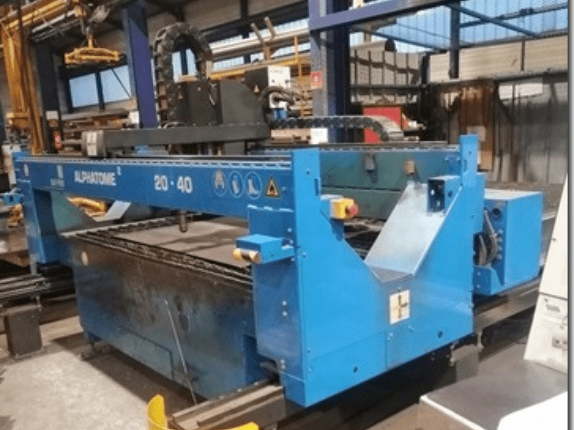 Modrý stroj ALPHATOME 20-40 CNC, pohled zepředu, s viditelným řezným prostorem a ovládacím panelem, určený pro přesnou výrobu.