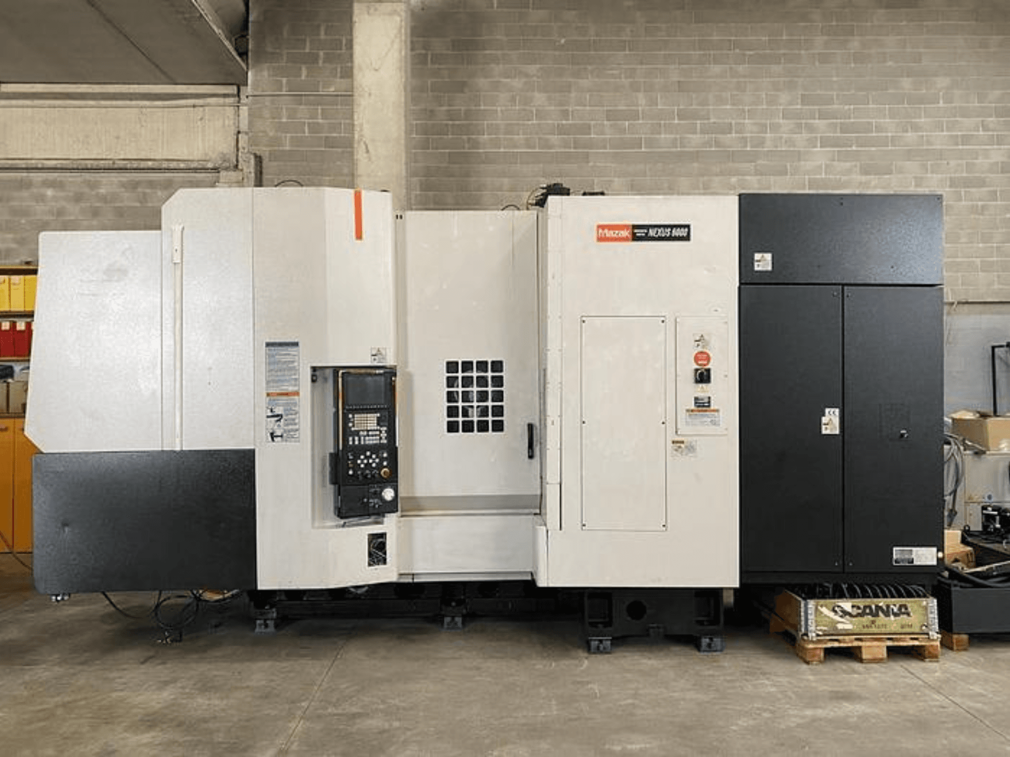 CNC soustruh Mazak NEXUS 6400, pohled zepředu, s ovládacím panelem, vypínačem a dvoubarevným bílo-černým krytem.