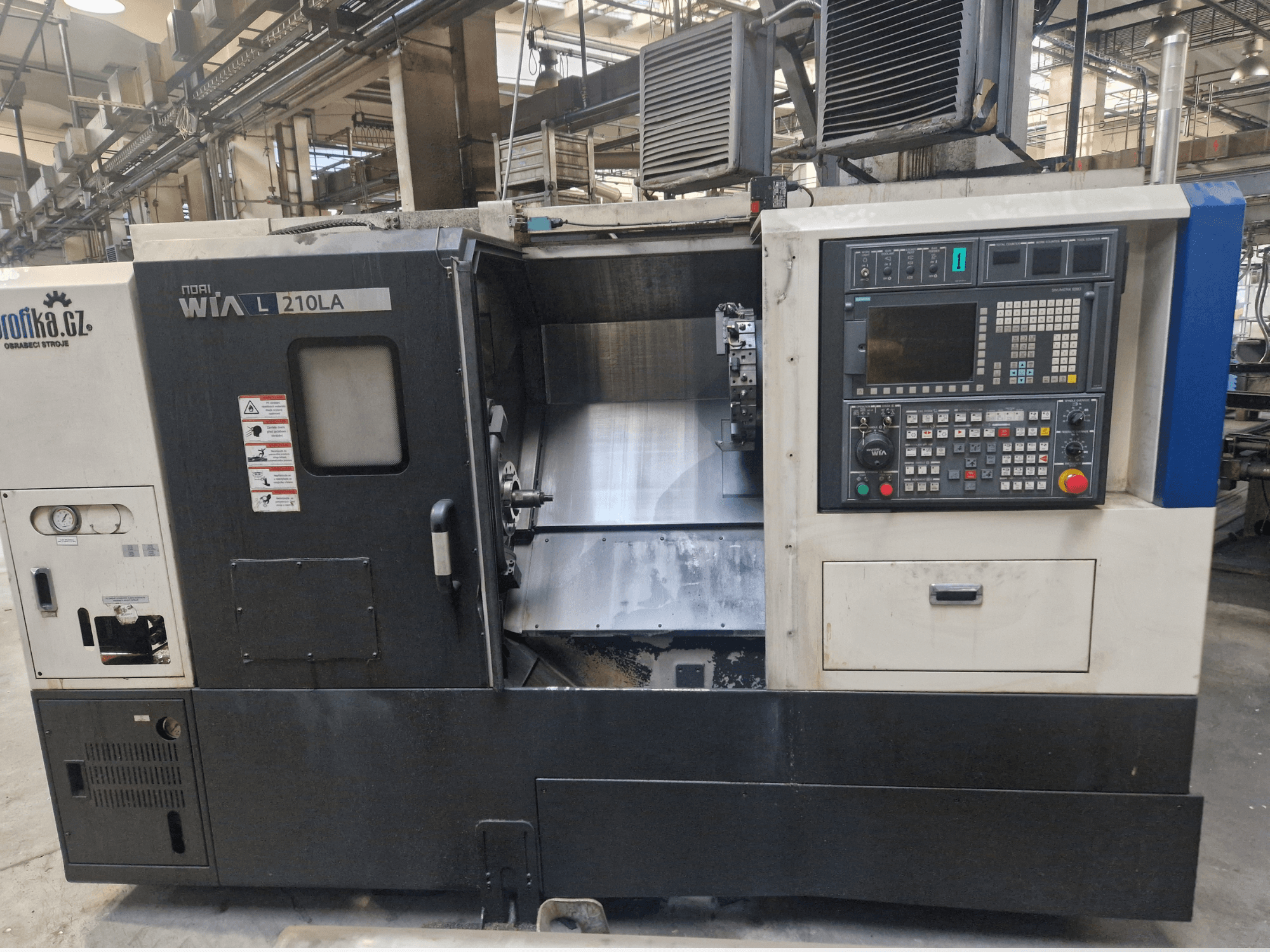 Soustruh WIA L210LA CNC, pohled zepředu, ovládací panel s tlačítky, displej a viditelný obráběcí prostor.