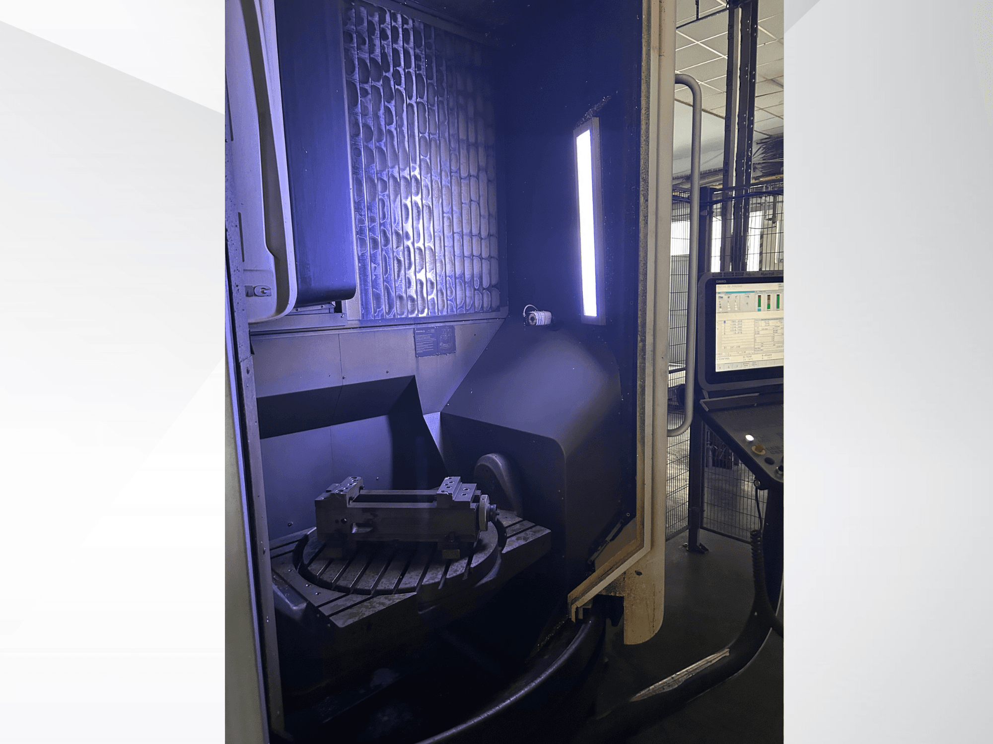Vertikální obráběcí centrum DMG MORI DMU 65 MonoBlock, pohled zepředu znázorňující otočný stůl s obrobkem a ovládacím panelem.