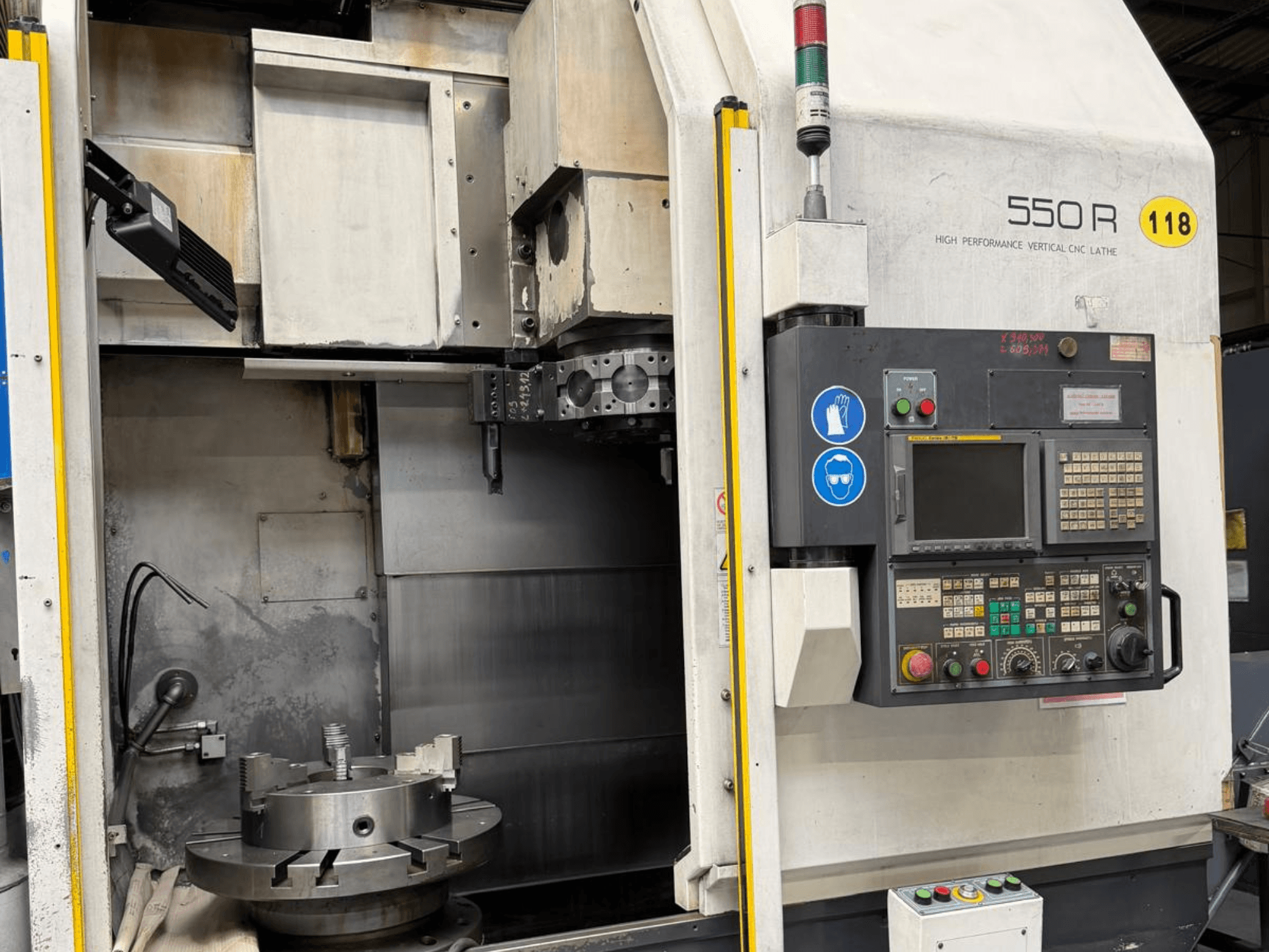 Vysoce výkonný vertikální CNC soustruh 550 R, pohled zepředu, zobrazující ovládací panel, otočné sklíčidlo a provozní součásti.