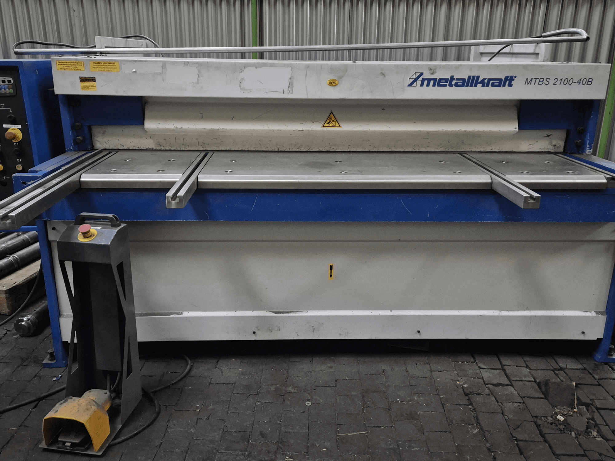 CNC stříhací stroj Metallkraft MTBS 2100-40B, čelní pohled na ovládací panel a střihací stůl s bezpečnostními prvky.