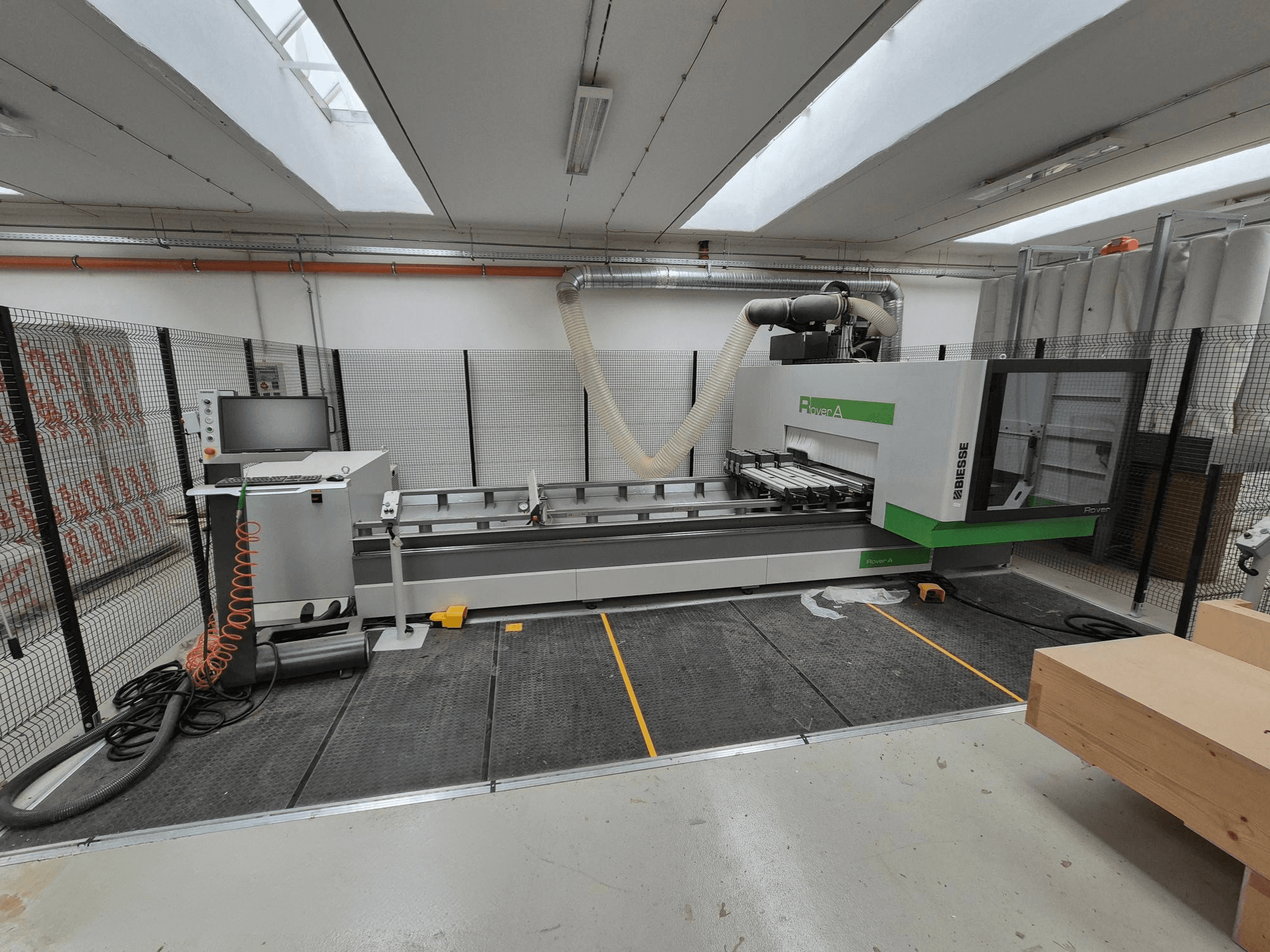 Biesse Rover CNC stroj v dílně, pohled zepředu. Obsahuje ovládací panel, vakuový systém a pracovní plochu.