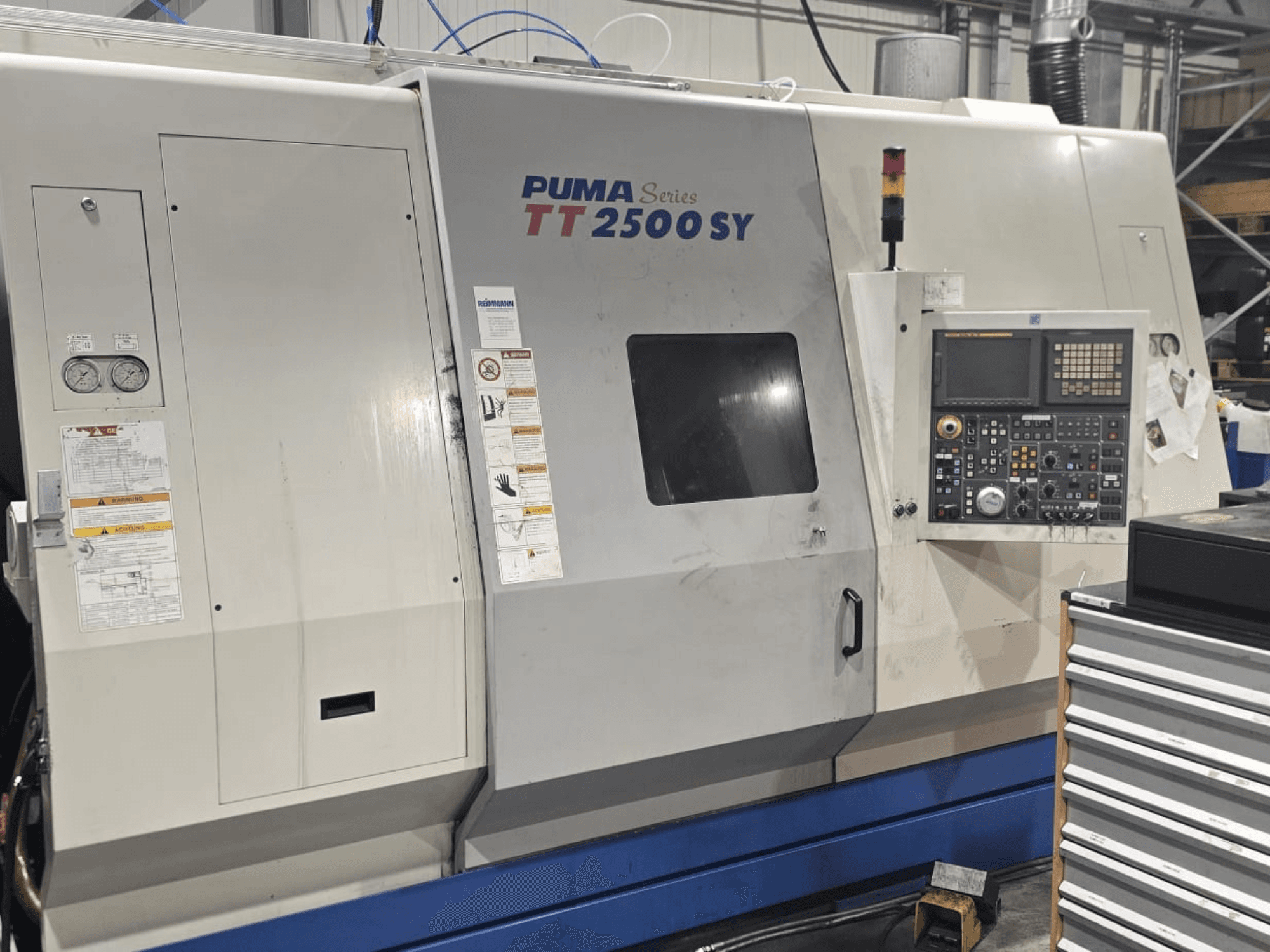 CNC soustruh PUMA řady TT 2500 SY, pohled zepředu; viditelný ovládací panel s číselníky a tlačítky, měřidly a popisky obsluhy.