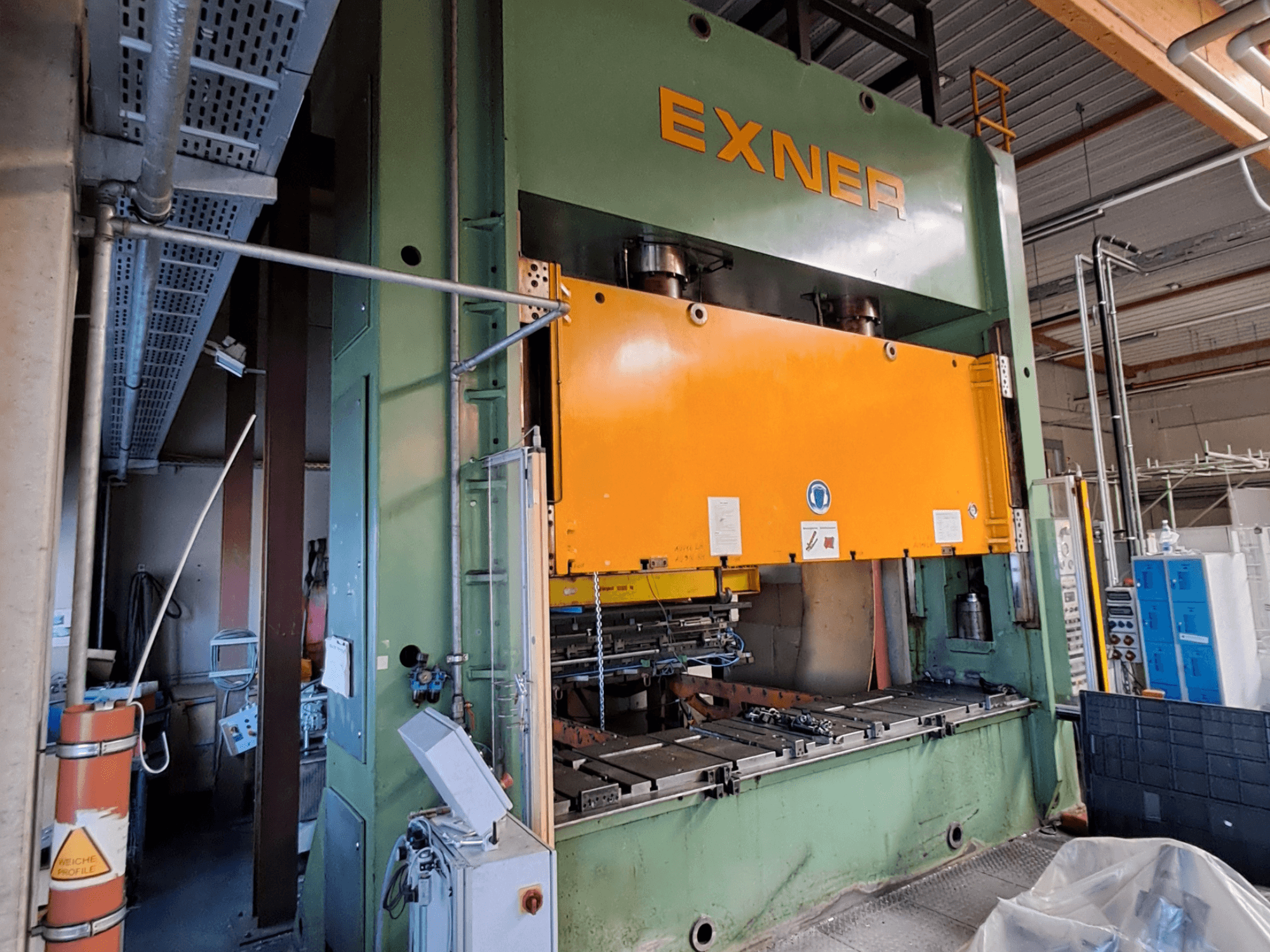 Hydraulický lis EXNER EX SBR 200 v bočním pohledu, s oranžovou lisovací deskou a viditelným ovládacím panelem.